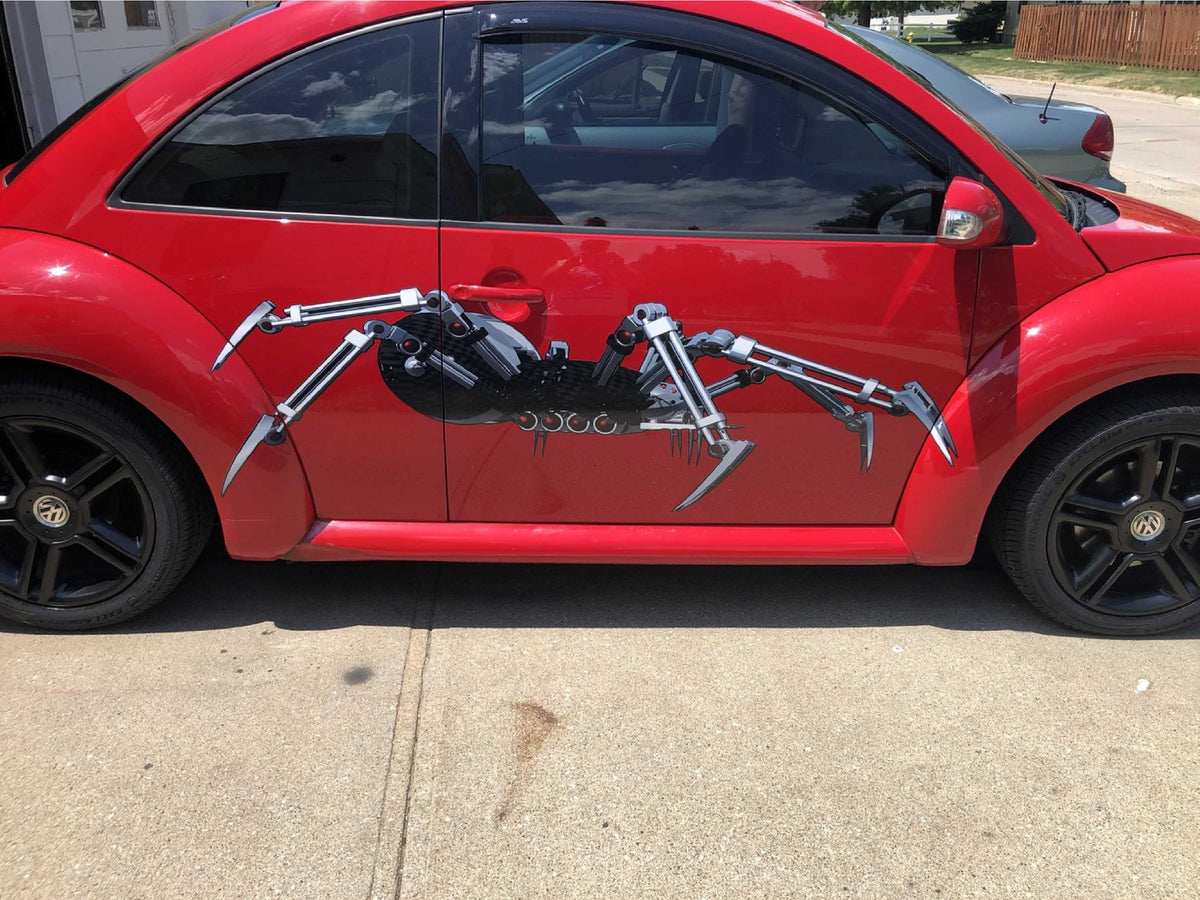 robot spider vinyl graphics on the side of red volkswagon beetle